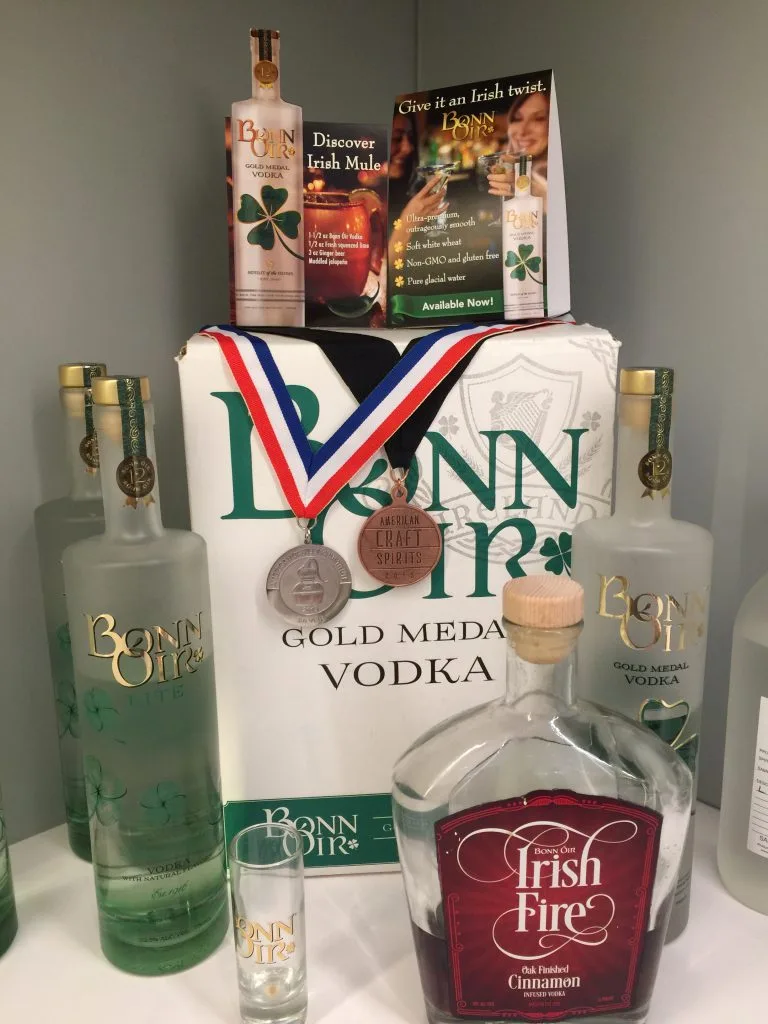 Bonn Óir bottles on display with medals draped over a Gold Medal Vodka case